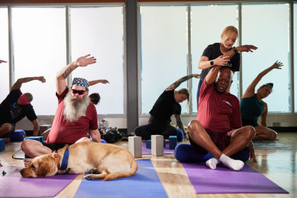 Two Blinded Veterans Association members, Rob and Sheldon, participating in a group yoga class at Ability360, an accessible fitness center in Phoenix.