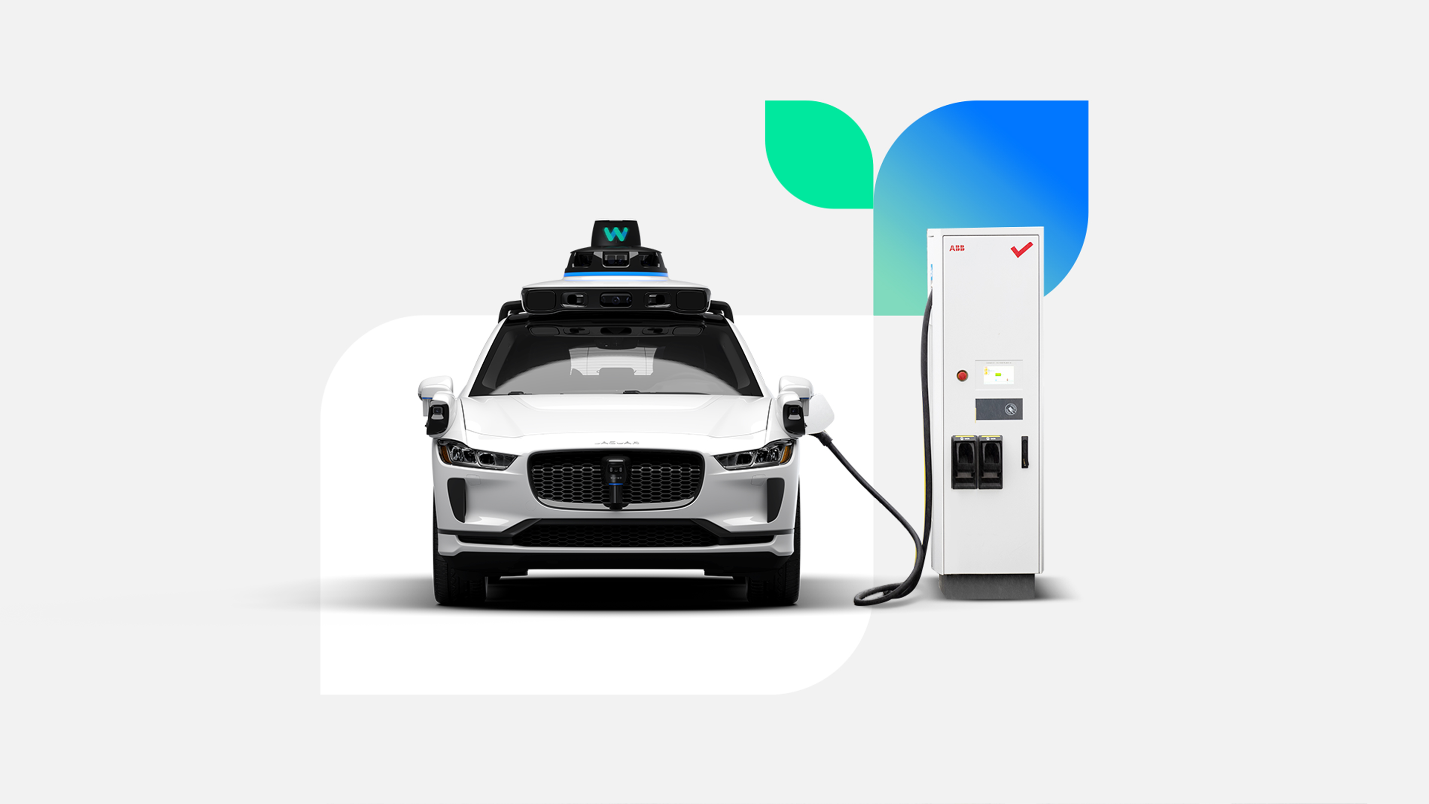 A Waymo Jaguar I-PACE charges at a charging station.