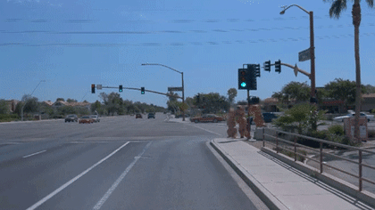 Camera video from the Waymo Driver in Arizona of people dressed up in inflatable dinosaur costumes
