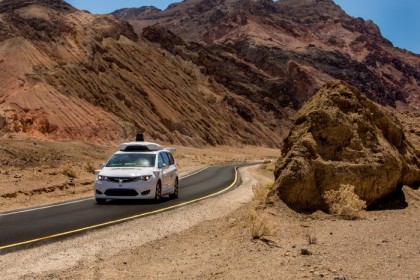 A white, Waymo Pacifica minivan in Death Valley