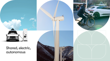 A modern collage evoking clean and sustainable imagery, including white clouds in a blue sky, a wind turbine in the mountains, a Waymo vehicle charging, and another Waymo vehicle sharing the road with a cyclist.   