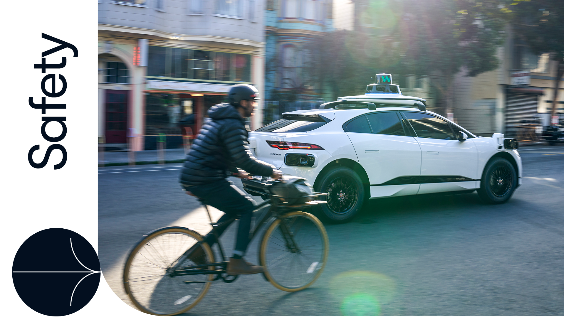 Bicyclist next to a Waymo car