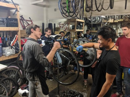 A photo of Waymonauts fixing bikes