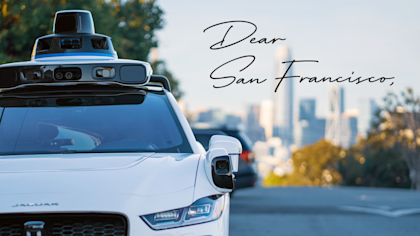 Waymo car in San Francisco with "Dear San Francisco" handwriting over the top