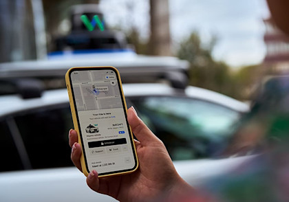 Rider looking at Uber app screen with Waymo arriving 