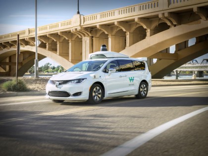 A photo of a white, Waymo Pacifica minivan 