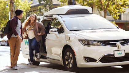 Passengers exiting Waymo car