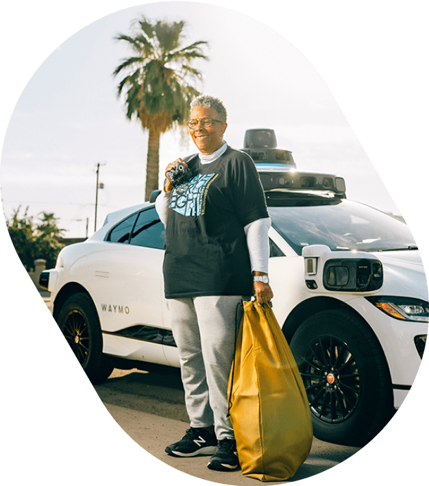 Social Spin partner in front of Waymo vehicle