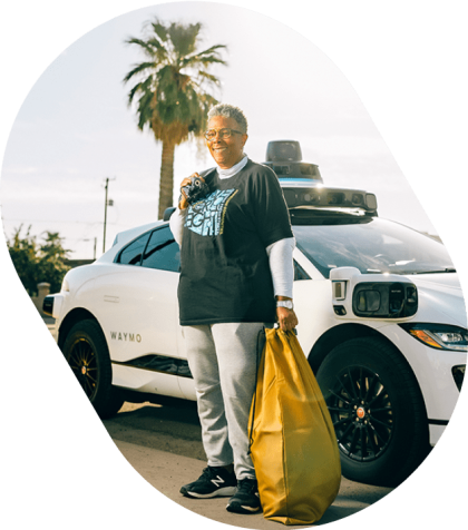 Social Spin partner in front of Waymo vehicle