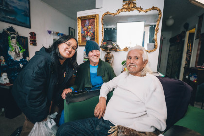 Aiah and David delivering groceries to Louie, an Openhouse community member