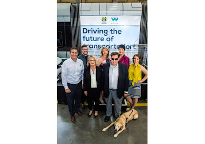 Valley Metro employees gathered at a joint press conference with Waymo in 2018. Ron Brooks, pictured with his guide dog, Potter, was the manager of accessible transit for Valley Metro.