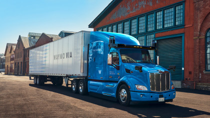 A photo of a blue Waymo Via truck 