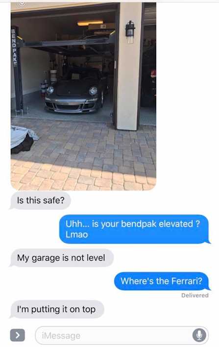 BendPak Four Post Lift Elevated on Blocks in Sloped Garage