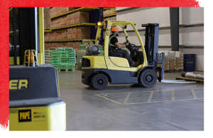 Forklift Moving Pallet Inventory Inside Warehouse Distribution Facility