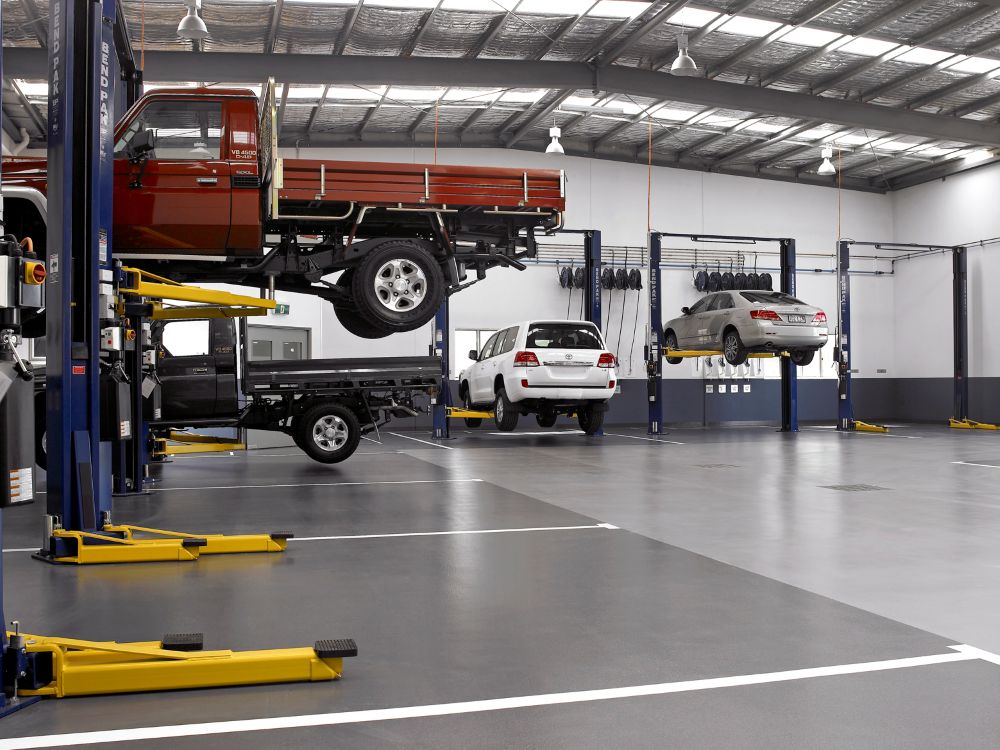 BendPak Four Post Lift Supporting Tracked Military Vehicle