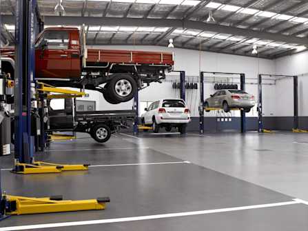 BendPak Four Post Lift Supporting Tracked Military Vehicle