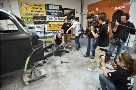 Automotive Shop Filming Car Restoration With Media Crew