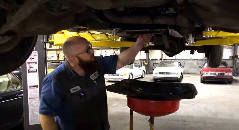 Car Wizard Working Under Vehicle on BendPak Lift