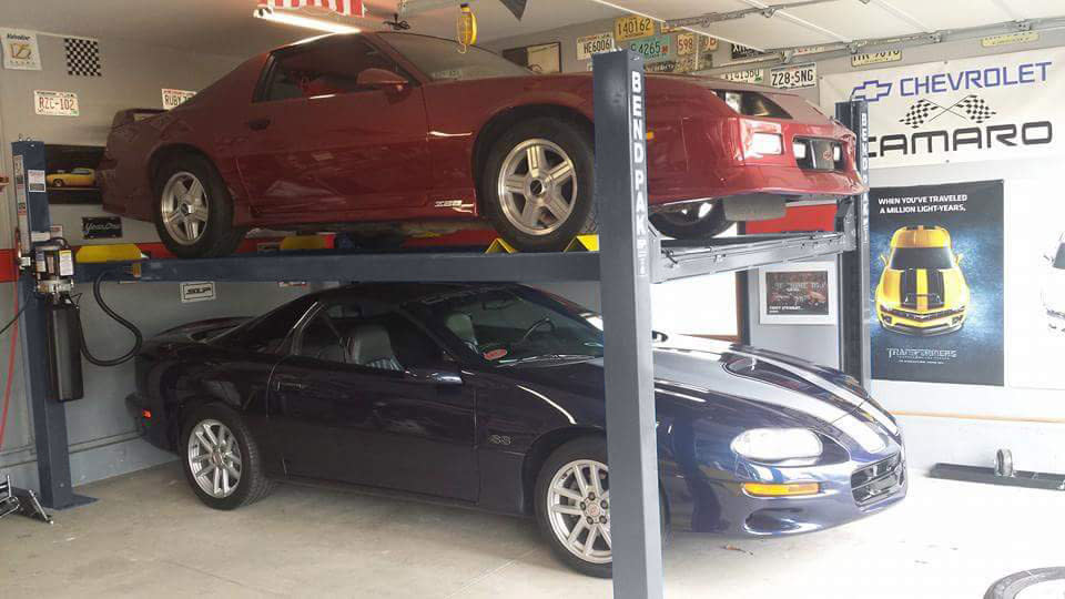 BendPak Four Post Lift Storing Camaro Over Sports Car