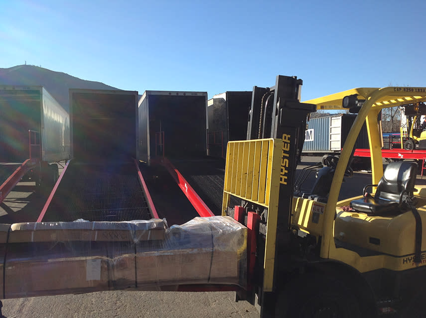 Forklift Loading Equipment Into Shipping Trailers