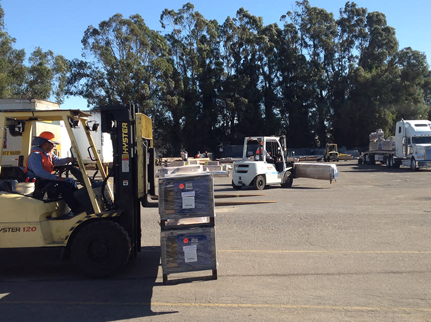 Warehouse Forklifts Moving Palletized Equipment