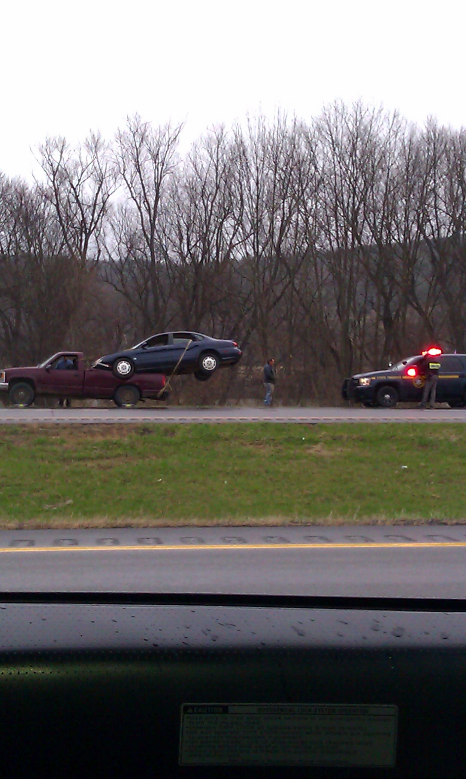 Unsafe Vehicle Transport With Car Strapped to Pickup Bed