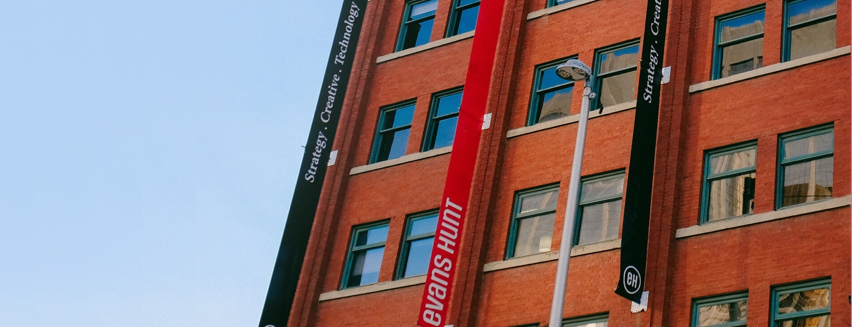 Exterior of our offices showing the “Strategy. Creative. Technology.” banners that announce our presence. 