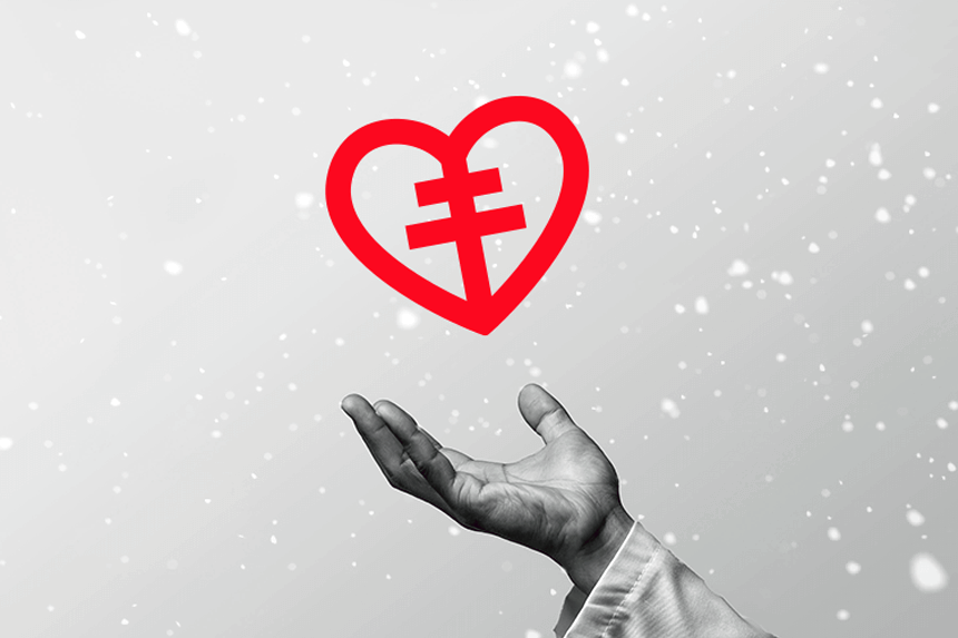 Hand håller i hjärt-lungfonden hjärtat med snö i bakgrunden