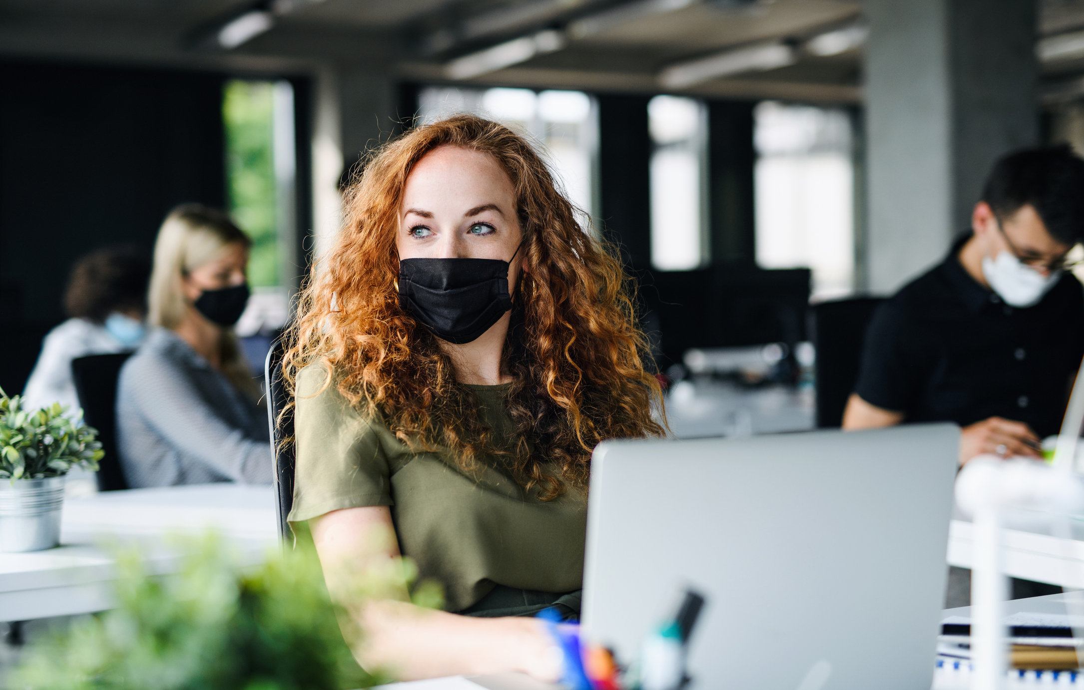 Woman wearing a mask, in an office