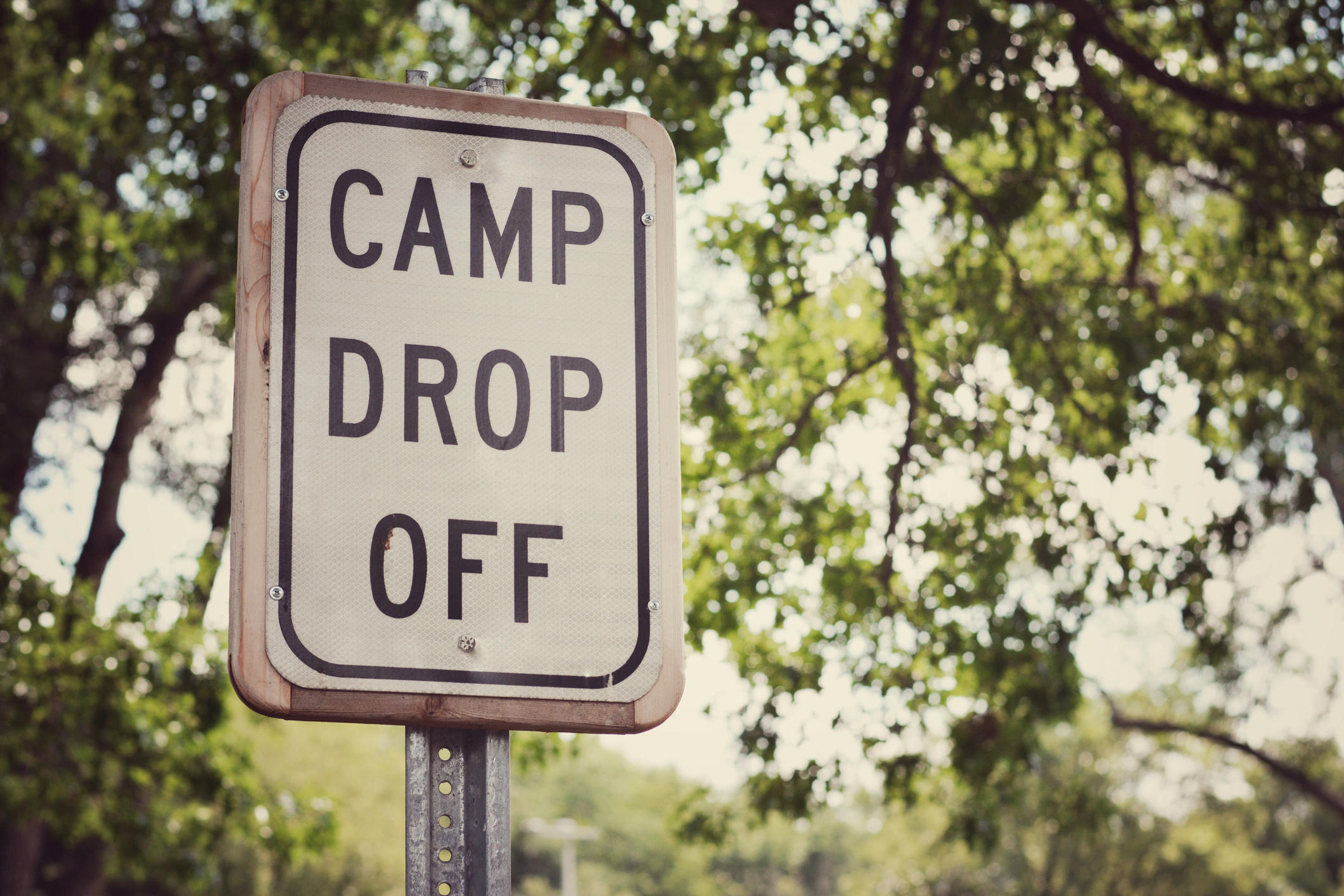 Outdoor image with a Camp Drop Off sign