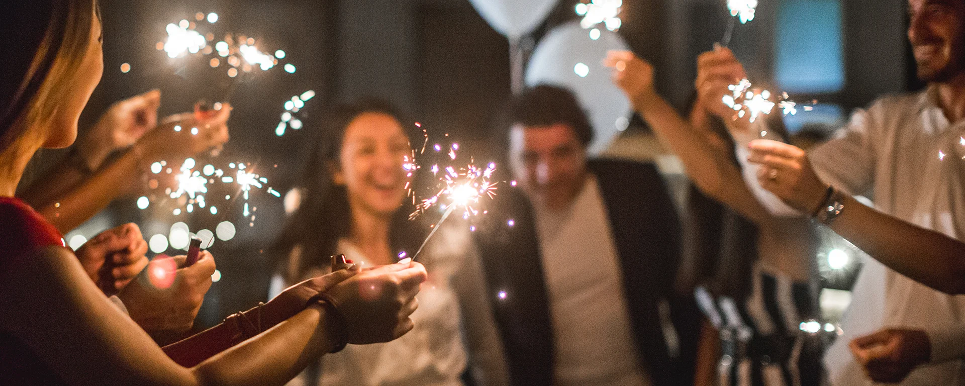 Group of people together, holding sparklers