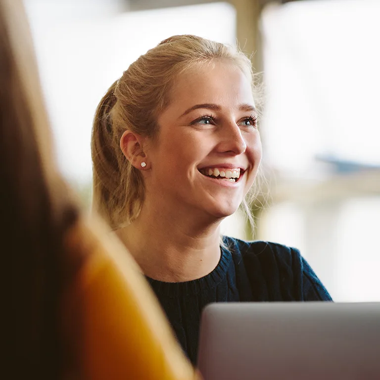 Woman, smiling, with laptop