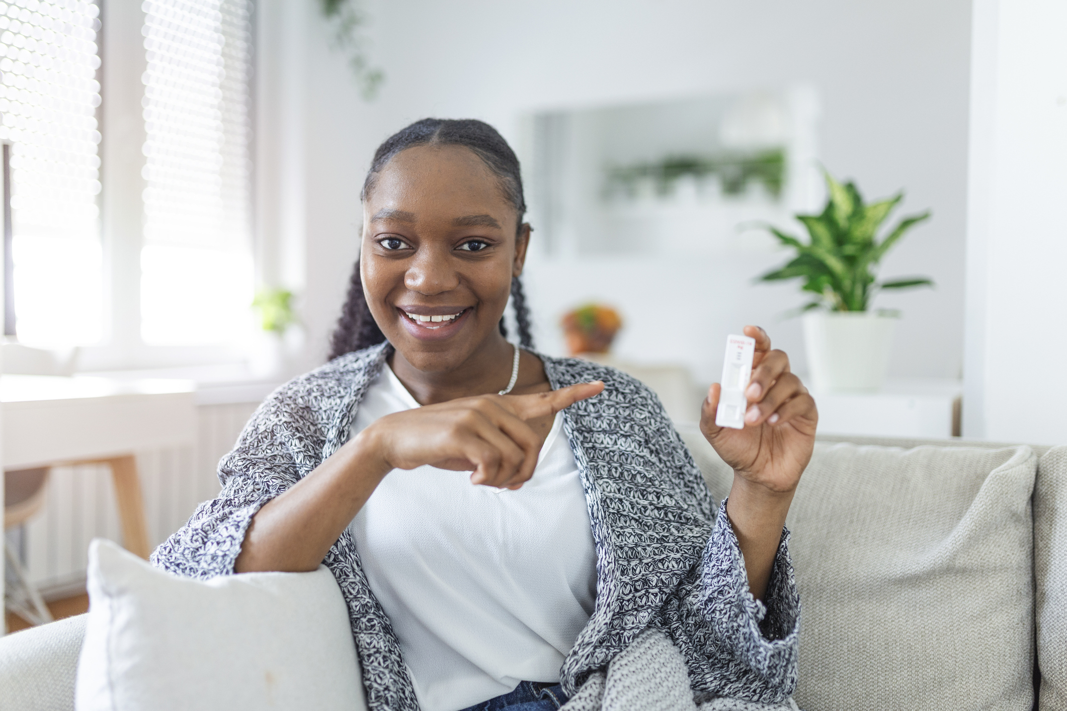 Woman pointing to a COVID test result