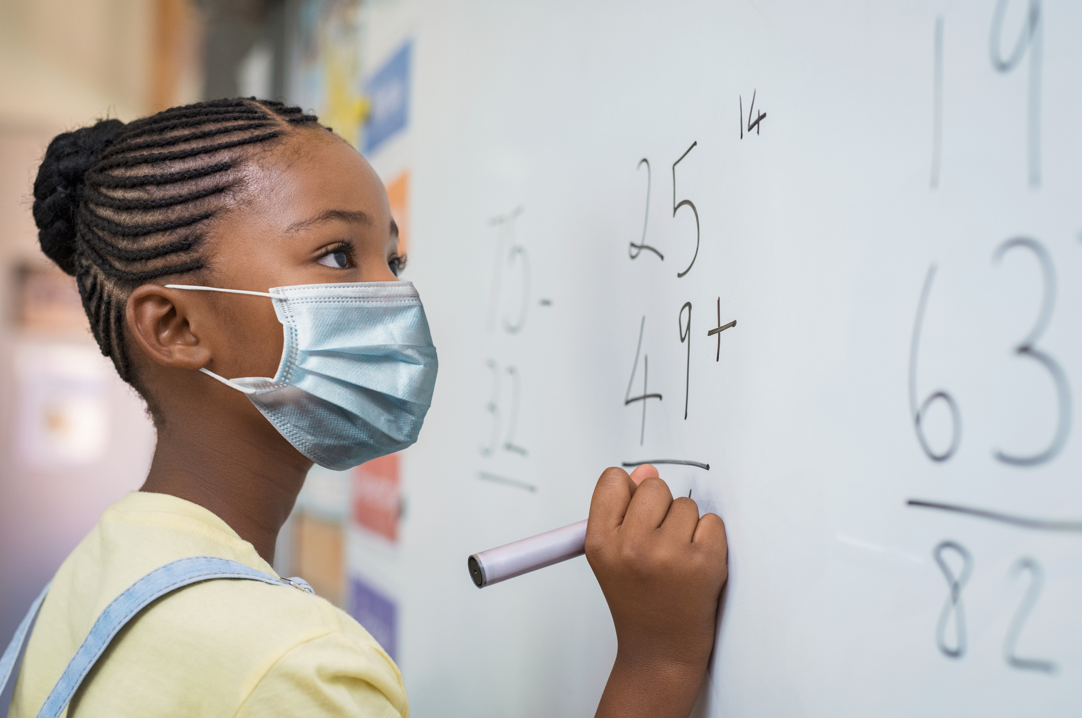 Girl in classroom wearing a mask