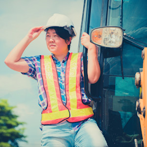 A backhoe operator surveying the jobsite before beginning work.