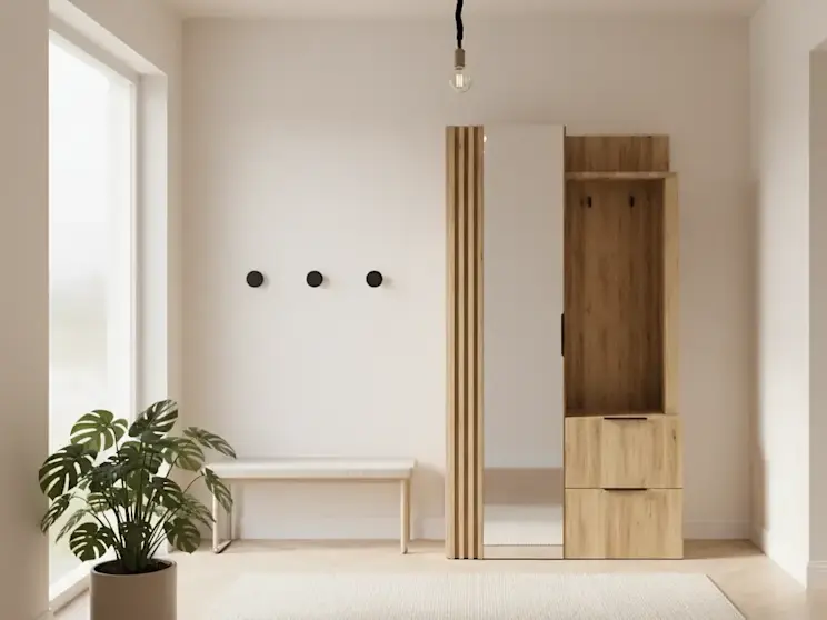 Nowoczesna garderoba Riganni w kolorze dębu artisan i bieli ustawiona w jasnym przedpokoju, wyposażona w lustro, szafkę i wieszak. Obok znajduje się prosta ławka oraz roślina doniczkowa, co tworzy przytulną i funkcjonalną przestrzeń wejściową.