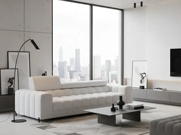 Biała sofa Festello w tkaninie Royal 01, zaprezentowana w nowoczesnym salonie z dużymi oknami i minimalistycznym wystrojem.