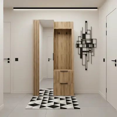 Nowoczesny przedpokój z garderobą Riganni w dekorze drewna, z panelem z wieszakami, szafką na buty i wysokim lustrem. Jasne ściany, czarne detale i geometryczny dywan tworzą uporządkowaną, elegancką strefę wejściową.