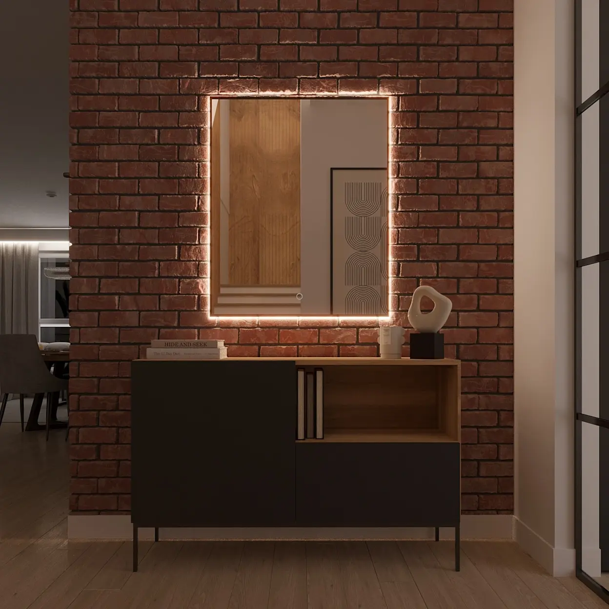 Lustro wiszące Vixisse z podświetleniem LED zawieszone na ceglanej ścianie w klimacie loft. Ciepła poświata tworzy nastrojowe światło nad nowoczesną komodą z czarnym frontem i drewnianą wnęką na dekoracje.