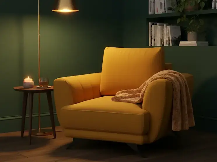 Musztardowy fotel Megis Nube 45 ustawiony w przytulnym salonie z zieloną ścianą, lampą podłogową i stolikiem pomocniczym.