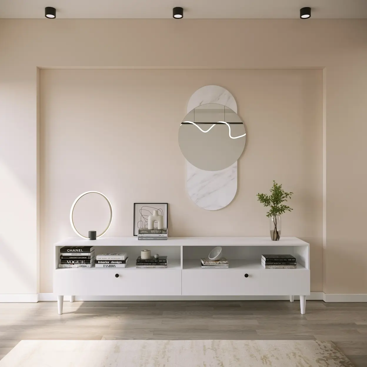 Biała szafka RTV Dullum w minimalistycznym salonie z beżową ścianą i dekoracyjną wnęką. Na blacie stoi nowoczesna lampa Vallum w formie świecącego okręgu oraz książki i dodatki, a nad szafką wisi designerskie lustro o owalnych kształtach.