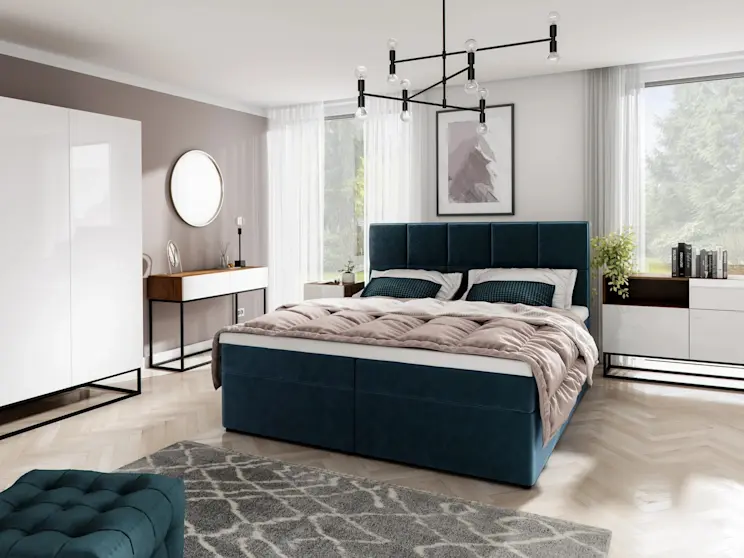 Nowoczesna sypialnia z łóżkiem tapicerowanym Glossy w tkaninie Monolith 77 w głębokim granacie. Wysoki, dzielony zagłówek, jasna pościel i beżowa narzuta, a obok toaletka z okrągłym lustrem oraz duże okna z lekkimi zasłonami.