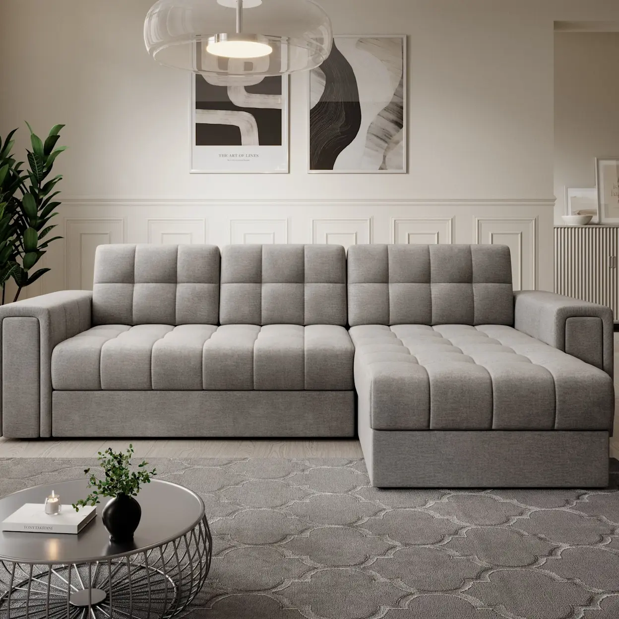 Inspiracja salonu z narożnikiem Blenvi Sola 18 w jasnoszarej tapicerce i pikowanych siedziskach. Całość dopełnia dywan Elsher Grey z delikatnym wzorem oraz okrągły stolik kawowy w nowoczesnym, jasnym wnętrzu.