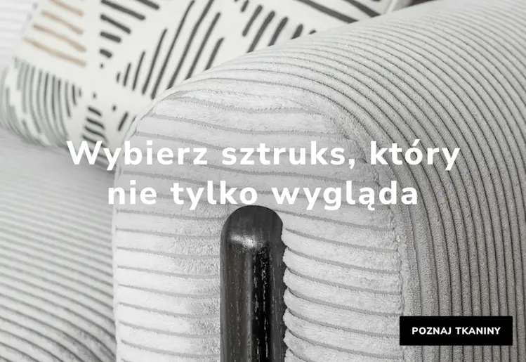 Zbliżenie na sofę Arcadova w jasnoszarej sztruksowej tkaninie Jarell 03 z podłokietnikiem i poduszką – baner ELTAP.