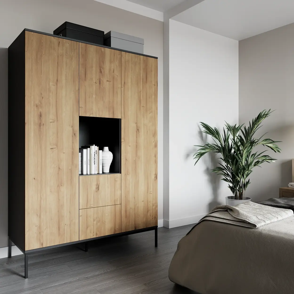 Szafa Lanzzi w dekorze dąb artisan z czarną ramą, ustawiona w nowoczesnej sypialni. Mebel ma otwartą wnękę na książki i dekoracje oraz wysokie fronty, a całość stoi na smukłych nóżkach, co dodaje lekkości aranżacji.