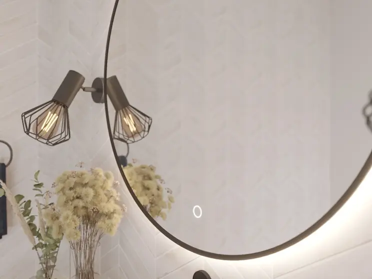 Detal lustra łazienkowego Orandiu LED: fragment okrągłej tafli z włącznikiem dotykowym i subtelną poświatą. Obok znajdują się czarne kinkiety oraz wazon z roślinami, co tworzy przytulną, nowoczesną aranżację łazienki.