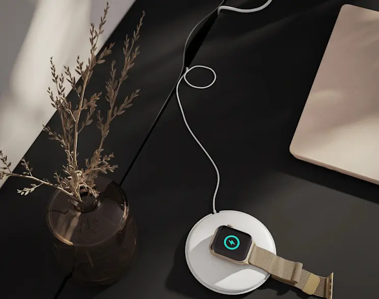 Czarne biurko Nevy w zbliżeniu prezentuje gładki blat z praktycznym schowkiem na kable, który pomaga utrzymać porządek na stanowisku pracy. Na blacie widać ładowarkę, przewód i laptop.