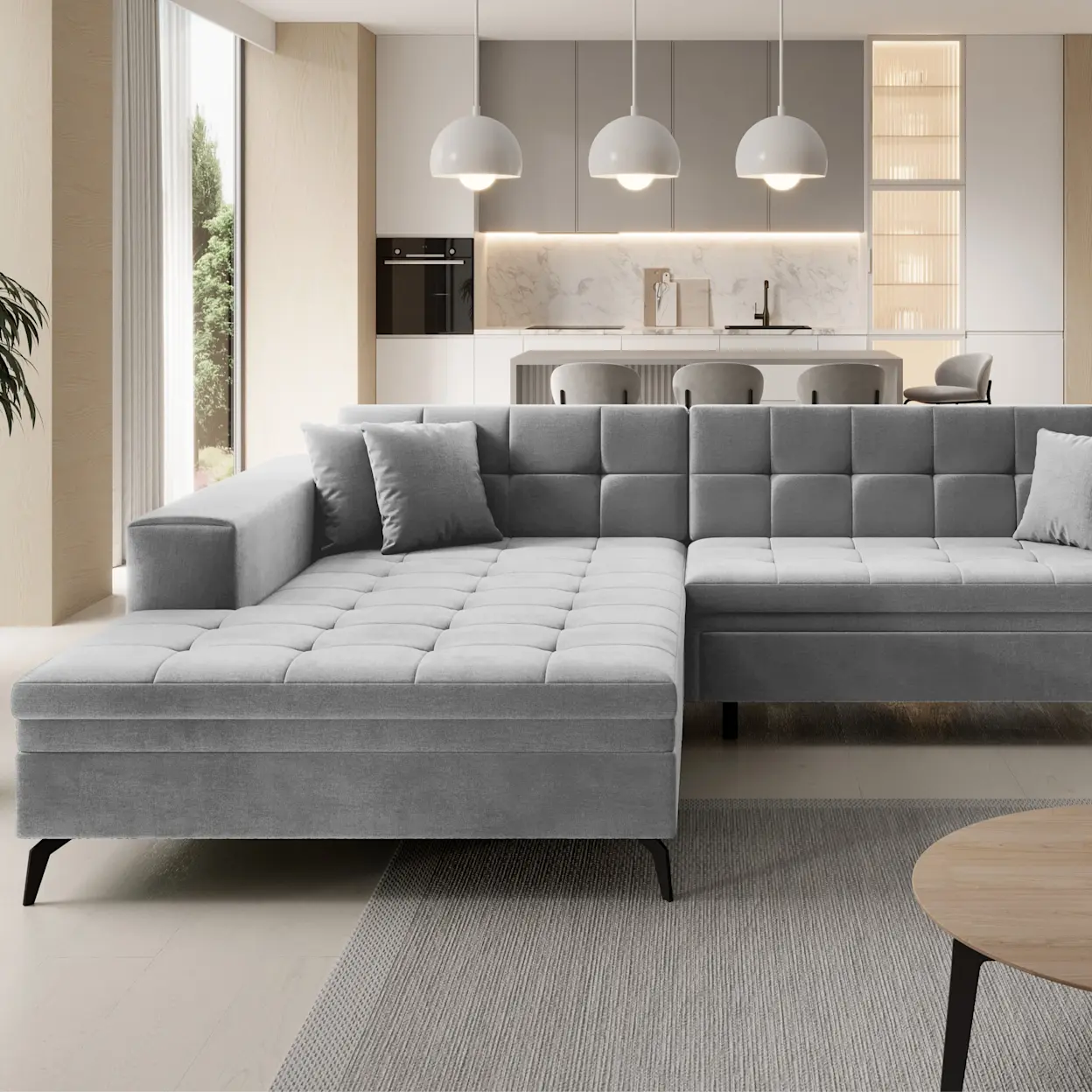 Szary narożnik Solange w nowoczesnym salonie z aneksem kuchennym. Pikowane siedzisko, prosta forma i elegancka kolorystyka.