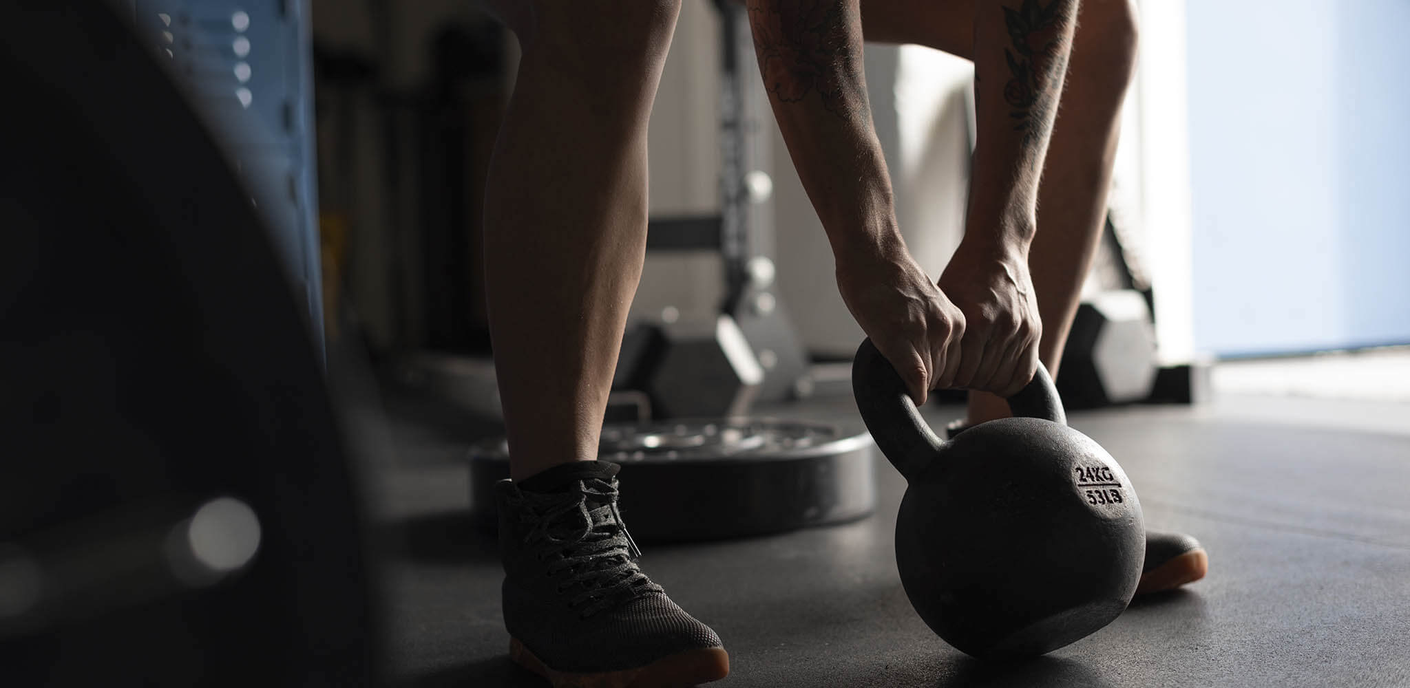 Pessoa se exercita com kettlebell em academia