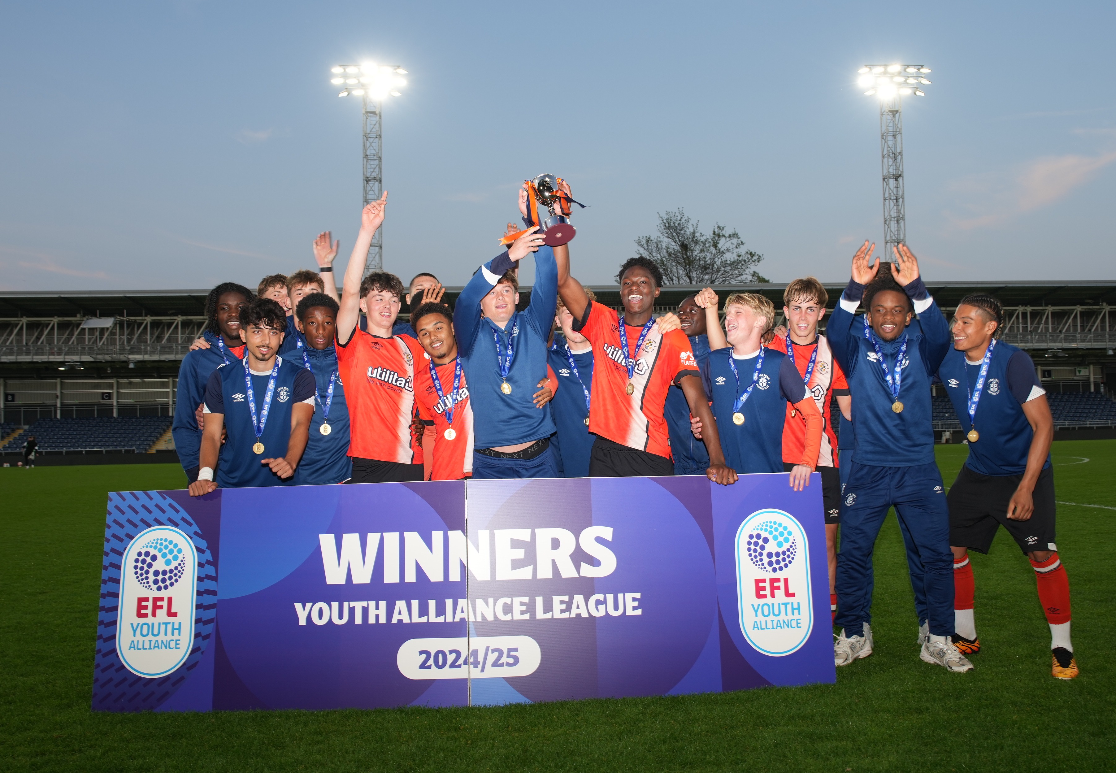 The Luton Town Under-18 squad lift the EFL Youth Alliance South Division trophy at half-time of the Under-21s' 2-2 draw with Oxford at Kenilworth Road.